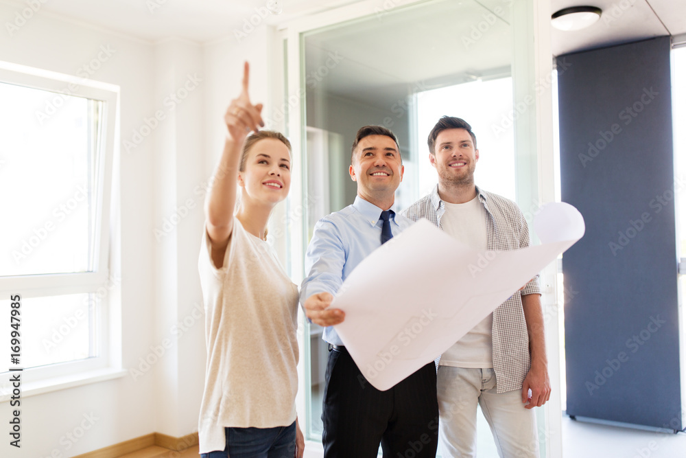 Poster realtor showing blueprint of new home to couple