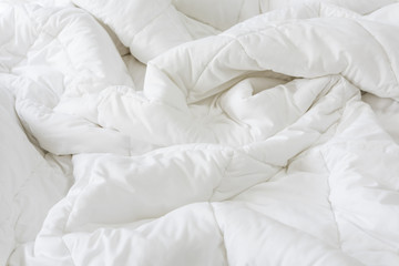 Close up messy white sheet and pillows on bed bedroom interior
