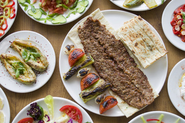 Adana Kebab; healthy and fresh salad varieties and appetizer on wooden table