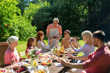happy family having dinner or summer garden party