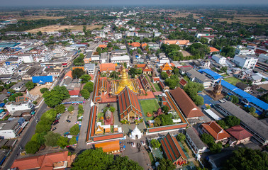Aerial view of Wat Phra That Hariphunchai pagoda temple important religious traveling destination in Lamphun province northern of Thailand. icture high resolution from DSLR camera shot on helicopter