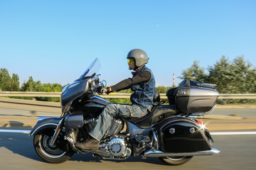Man riding his black motorcycle on the road