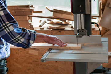 Cutting pine board at the band saw