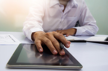 businessman working with business documents on office table with digital tablet computer and graph finance diagram in the background