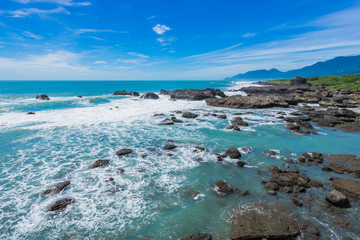 Naklejka na ściany i meble Panoramic view of beautiful sea level with reef rocks under fantasy blue cloudy and sunshine sky in Sansiantai Taitung, Taiwan