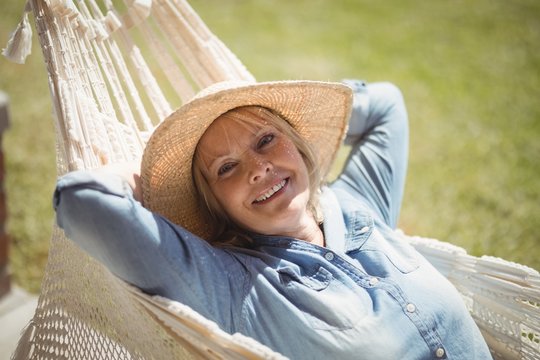 Smiling Senior Woman Relaxing On Hammock
