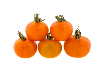 small orange tomatoes on a white background