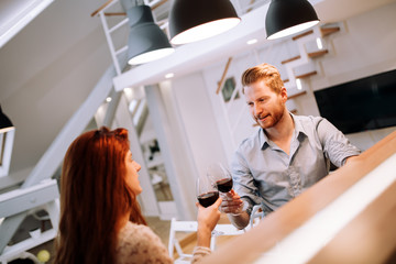 Beautiful couple toasting with wine