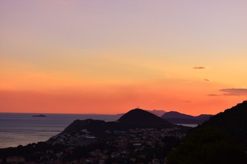 colorful sunset over city mountains on background 