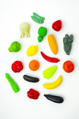 Group of vegetable and fruit plastic toys for children in isolated white background