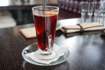 Glass mug with mulled wine on a wooden table in a seaside cafe Zelenogradsk