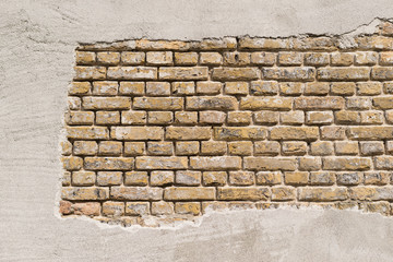 Masonry in a so-called standing brick bond with stucco.