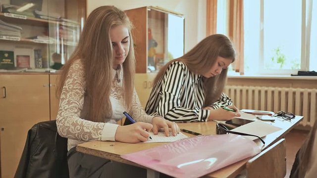 Russian school. Pupils write a control exam in their notebooks.