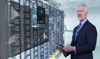 Senior businessman in server room
