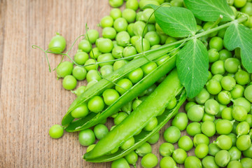 Fresh green peas on a wooden table