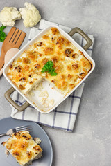 Cauliflower casserole on concrete background. Top view, copy space.