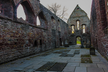 Interior view at sunset during autumn or early winter of the ruins of Beauly Priory in the Scottish Highlands.