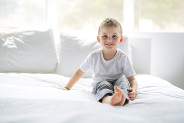 Young Boy sit on bed at home