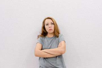 Portrait of Very Frustrated and Angry Woman, Woman screaming, headache. Portrait of Female Face. Attractive Model Face Mad, woman in Studio. beige background