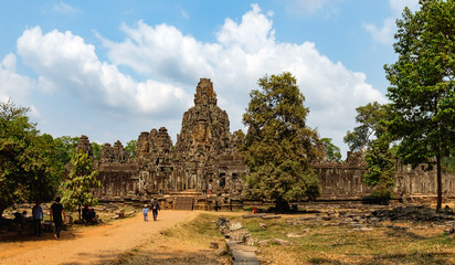 Unidentified tourists visit to Prasat Bayon in Angkor Thom Complex, Siem Reap, Cambodia. Ancient Khmer architecture, famous Cambodian landmark, World Heritage