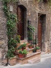 Fototapeta na wymiar Assisi, Italy. Facade, doors and plants.