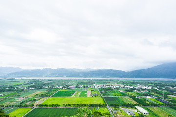 Fototapeta na wymiar Panoramic bird eye aerial view of beautiful field and mountain under fantasy cloudy sky in Luyeh Hill, Taitung, the famous attractions in Taiwan