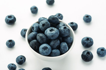 Blueberries in a white ceramic bowl, closeup shot