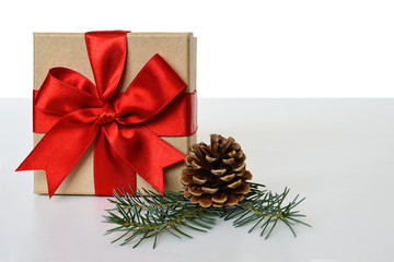 Obraz na płótnie Canvas Christmas gift, pine cone and spruce branches