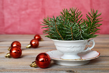 Christmas decoration: Christmas balls and spruce branches arranged in porcelain cup