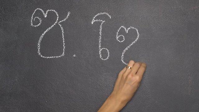 Woman's hand writing Thai letter "ซ" with white chalk on blackboard