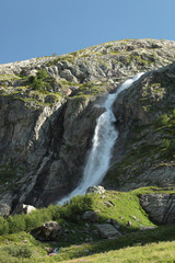 Fototapeta na wymiar Beautiful high powerful mountain waterfall