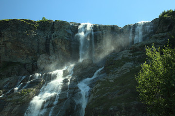 Beautiful tall wide mountain waterfall
