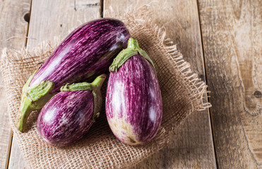 Harvest of striped eggplant on a wooden background