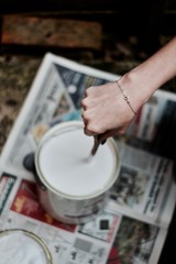 Fototapeta na wymiar Woman shakeing white paint