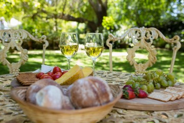 Fototapeta na wymiar Wine glasses and food on table