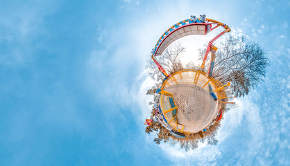 Little planet with amusement park, trees and cold blye sky. Nice background.