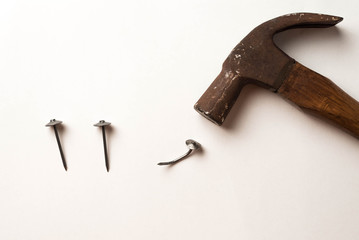 nail and Hammer strike nail on isolated background