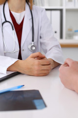 Close up of a doctor and patient hands while discussing medical records after health  examination