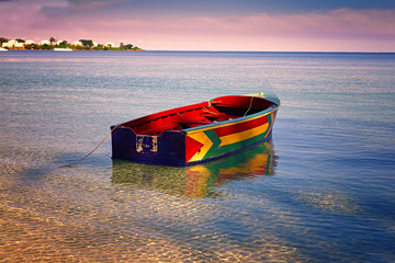 Traditional Jamaican fishing boat floating out from the beach on Bloody Bay, Jamaica. © V. J. Matthew