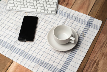 Business concept. Office supply on desk table with cup of coffee and analysis chart, smartphone, keyboard, notebook, on desk.