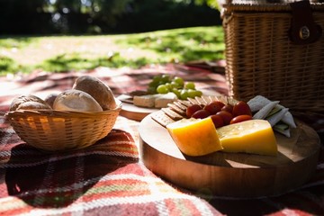 Bun, cheese, cracker biscuit on picnic blanket