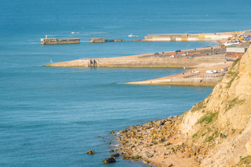From Ecclesbourne Glen across blue sea English Channel site of proposed marina development to Hastings' beach