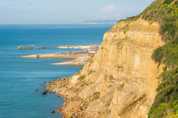 From Ecclesbourne Glen across blue sea English Channel site of proposed marina development to Hastings' beach