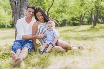 Fototapeta premium Happy Family Having fun with baby playing In The Park.
