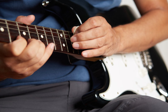 Close up of a lefty electric guitar being played