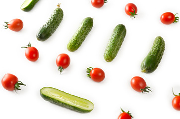 Fresh vegetables - cucumbers and tomatoes on white background. Pattern flat lay.