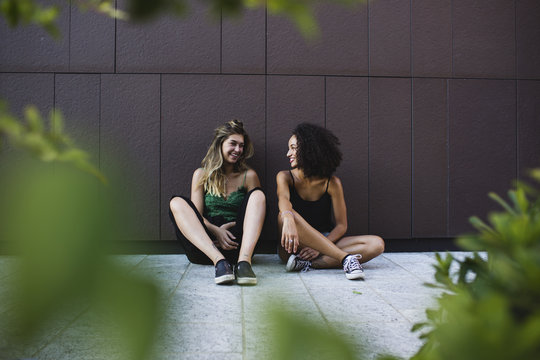 Two happ friends chatting together
