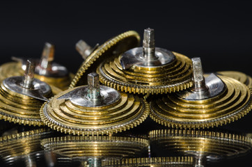 Watch Repair: Vintage Pocket Watch Fusee Cones Resting on a Black Surface