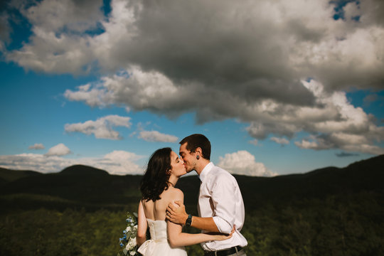 Happy Couple Kissing on Mountaintop