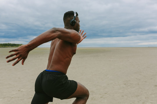 Young Black Man Training on the Beach - Powered by Adobe